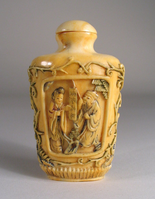 DESCRIPTION:  A good antique ivory snuff bottle, each side deeply carved with garden scenes inside rectangular cartouches, surrounded by graceful scrolling vines. On one side a man and woman read a scroll while on the other a scholar instructs a young boy.  Once polychromed, the colors have been worn away through usage and handling.  Dating from the 19th C. Qing Dynasty (probably mid 1800’s), the bottle is in good condition; short age fissures are visible at the top shoulder and one side of the footed base. DIMENSIONS:  3” high (7.6 cm) x 1 7/8” wide (4.8 cm).<div id='rater_target1126948'></div>
