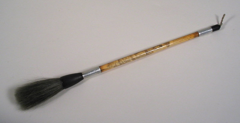 DESCRIPTION:  One of the four treasures of the scholar’s studio, this rare scholar’s brush is crafted from ivory (not bone) and engraved with a maiden in a garden setting as well as a poem in tiny characters.  The shaft is banded with silver foil and attaches to the ferrule and tip which are crafted from horn. Qing Dynasty, very good condition with a few hairlines but no open fractures.  DIMENSIONS:  12 ½” long (31.7 cm). <div id='rater_target1188540'></div>
