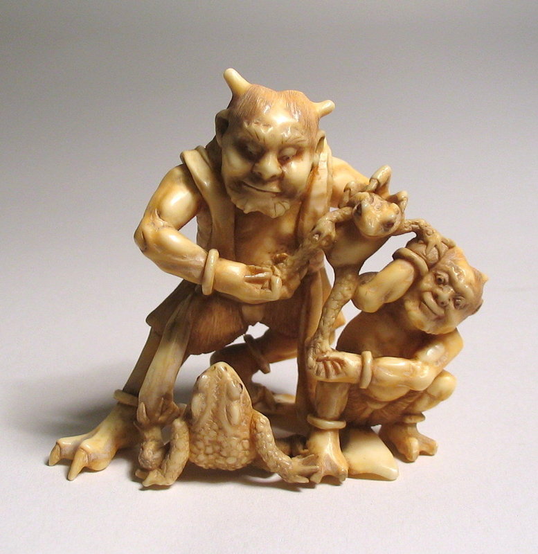 DESCRIPTION:  A skillfully carved Japanese ivory okimono of two oni struggling to capture two frogs.  A large horned oni holds one frog pinned down between his feet while he and a smaller oni struggle to subdue a smaller frog in their grasp.  Signed on the base, this amusing okimono from the Meiji Period is finely carved on all sides and in excellent condition.  DIMENSIONS:   2 1/2" high (6.5 cm) x 2 1/2" wide (6.5 cm). <div id='rater_target1231871'></div>
