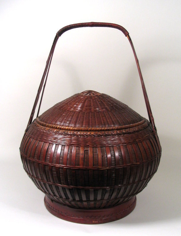 DESCRIPTION:  This wonderful Chinese bamboo basket is one of the nicest we've ever offered.  Pleasing in form and expertly handcrafted, the entire basket is tightly woven from bamboo strips in various sizes, forming a pleasing design.  Chinese characters are found inside the removable, cone-shaped lid.  Three long bent bamboo strips form the handle.   Very attractive and in excellent condition.  DIMENSIONS:  24" high including handle (61 cm) x 18" diameter (45.7 cm).  <div id='rater_target1233388'></div>
