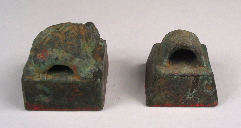 for the pair<br /><br />
DESCRIPTION:  The art of Chinese seal making developed from very ancient times.  First seen as molded clay stamps, bronze seals then appeared in an embryonic form in the Shang and Zhou dynasties (1600 BC – 256 BC).  This pair of small bronze seals are an excellent representation of the early forms of Chinese seal making.  The simple square seal pictured dates from the Han dynasty or earlier (206 BC – 220 AD), while the seal with a tortoise dates from the Tang or Song Dynasty (618-1279 AD). 
<p>The early bronze seals, mostly bearing rank titles of government officials and military officers, were almost uniformly small, unadorned and had perforated knobs for hanging from belts as badges of identity.  As seals came to be used on paper, they evolved into a more vertically elongated form which made them easier to grasp.  In the Tang and Song periods, carvings of animal forms were added, such as the zodiac animals or the four spirit creatures (the dragon, tiger, phoenix, and tortoise).  Later seals tend to be carved from stone and have more highly developed and elongated figures of dragons or fu dogs (Buddhist lions) as knobs.  DIMENSIONS:  Largest seal with tortoise measures 3/4” square (2 cm) x 3/4” high (2 cm).  
<div id='rater_target1239089'></div>
