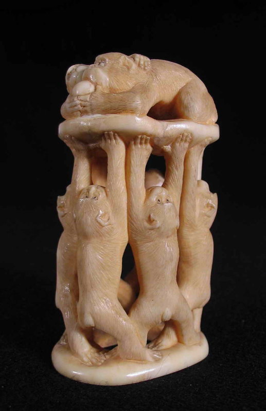 DESCRIPTION:  An appealing and well carved Japanese okimono of six standing monkeys, arms stretched upwards, holding two additional reclining monkeys high above them.  One of the reclined monkeys is warily eating fruit while the other feigns devotion in order to get a bite for himself.  The detail on this carving is quite good as evidenced by the finely delineated fur, and the tiny ears and hands that are perfectly carved. The base is signed and decorated with a double leaf mark. Meiji Period (1886 – 1912), and in good condition with minor hairlines. DIMENSIONS: 3 ½” high (9 cm) x 2” wide (5 cm).  

<p>NOTE:  Ancient East specializes in pre-1945 Asian art and antiques (corresponding to the end of WWII, the Republic of China period, and Japan's Showa Period). Carved works of art are composed of various materials, some including ivory or other endangered species.  We support the goal of eliminating the on-going criminal poaching of endangered animals.  Because we support conservation efforts of live populations, we only feature works of art crafted from these species that are genuine antiques.  However, we believe these antique works of art should also be preserved, and have much to offer on behalf of artistic, historical and cultural appreciation.  Prospective purchasers are advised that a number of countries prohibit the importation of property containing endangered species products. We at Ancient East follow all current laws relevant to their sale, import and export.  
<div id='rater_target1285291'></div>

