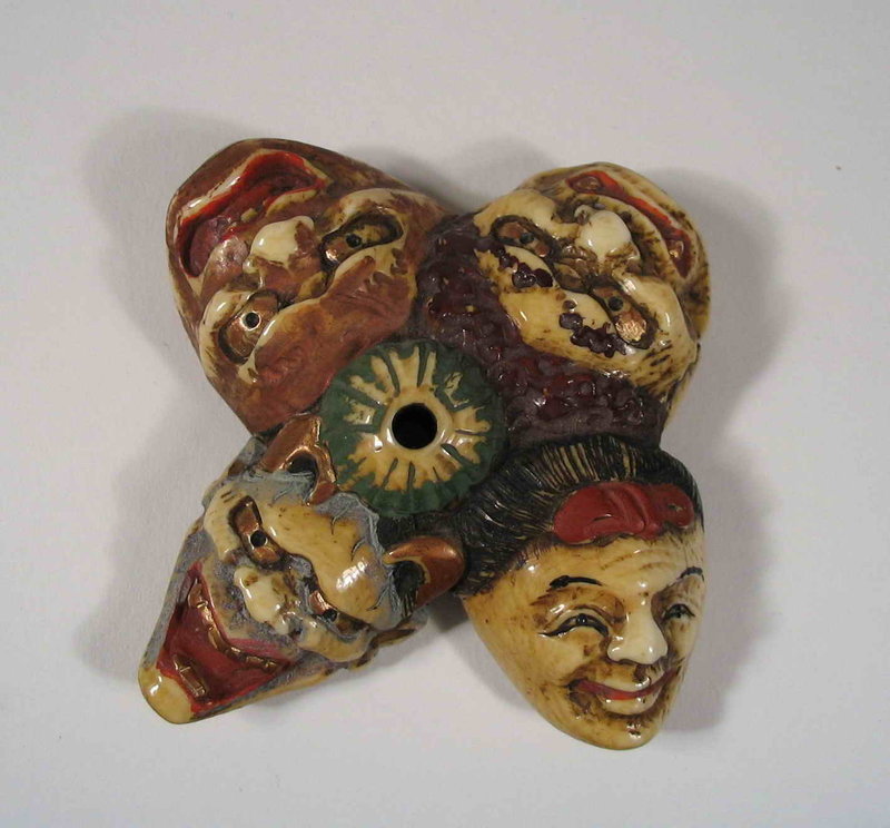 DESCRIPTION:  A good late Edo Period ivory manju netsuke of four polychrome Noh theatre masks surrounding a central, raised himetoshi (the hole for threading the cord).  Each mask is quite detailed and expressive with much of the original color remaining.  The netsuke is signed “Sadamitsu (Joko)” on the reverse and dates from the early to mid 19th C.  DIMENSIONS:  Approximately 2 ½” in diameter (6.5 cm).  
<p>NOTE:  Ancient East specializes in pre-1945 Asian art and antiques (corresponding to the end of WWII, the Republic of China period, and Japan's Showa Period). While we support the goal of eliminating the on-going criminal poaching of endangered animals, some antique works of art are composed of ivory or other endangered species.  Because we support conservation efforts of live populations, we only feature works of art crafted from these species that are genuine antiques.  We believe these antique works of art should also be preserved, and have much to offer on behalf of artistic, historical and cultural appreciation.  Prospective purchasers are advised that a number of countries prohibit the importation of items containing endangered species products. We at Ancient East follow all current laws relevant to their sale, import and export.
<div id='rater_target1286898'></div>
