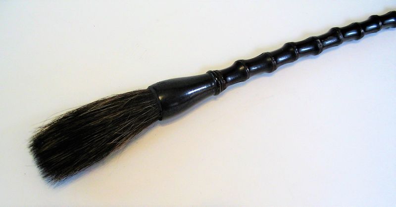 DESCRIPTION:  A handsome scholar's calligraphy brush, crafted using a dark brown bamboo for the shaft which connects to a shaped horn ferrule and long, natural bristle brush. One of the "four treasures of the scholar’s studio," this striking scholar’s brush would have been used for calligraphy or painting. This attractive, well made brush dates from the early 20th C.  DIMENSIONS: 13.25” long (33.5 cm).
<div id='rater_target1365926'></div>
