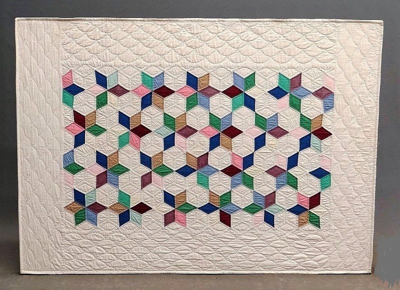 SOLD<br /><br />
DESCRIPTION:  A lovely mounted crib quilt in a tumbling blocks pattern, the colors making the optical illusion of six point stars. Quilt is mounted with light sewing onto stapled muslin, and can be hung in two directions. From the collection of a Pawling, New York collector.  DIMENSIONS:  39" x 54". 
<div id='rater_target1366200'></div>
