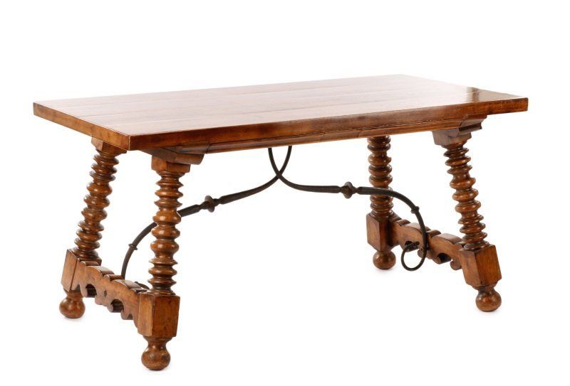 DESCRIPTION: An outstanding, solid walnut, trestle-form refectory table comprising four hand-turned splayed legs raised on ball feet, each pair joined by a thick, scrolling wood stretcher.  The legs are attached to a solid single-plank rectangular top with two hidden drawers to one side. Beautiful scrolling iron stretchers attach the underside plank with the wood stretchers for strength and stability. This handsome, sturdy table could be used as a desk, for dining, or as a library table; Spanish, 19th century. Very good condition. DIMENSIONS: 30" high x 60” long x 30.25” wide.
<div id='rater_target1366460'></div>

