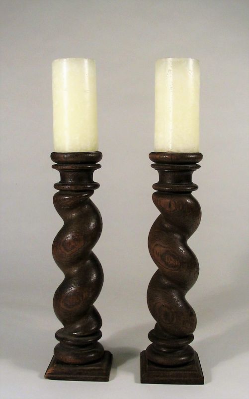 Pair<br /><br />
DESCRIPTION: A handsome pair of turned wood candle stands in the William & Mary barley twist style, 19th C.  A lovely addition to your table or mantel, these would provide old world charm in a country, cottage or Spanish Colonial decor. Very good condition, candles not included. DIMENSIONS: Without candles, 12.5” high, base is 3.5” square.
<div id='rater_target1367417'></div>
