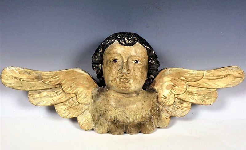 DESCRIPTION: An engaging carved wood santo figure of a winged cherub, most likely carved in the Philippines. This figure, dating from the early 1900’s, is depicted with black hair, inset glass eyes and extended wings. CONDITION: Some age appropriate losses to original paint. DIMENSIONS: 6.5" high x 16" wide.   
<div id='rater_target1370696'></div>
