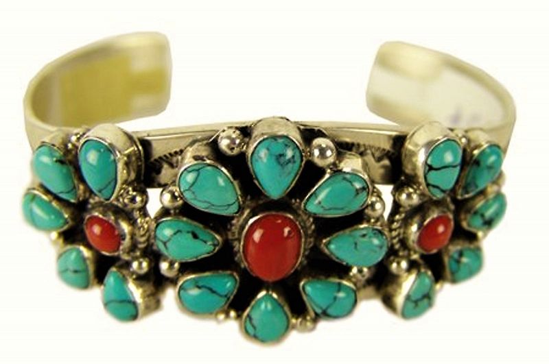 DESCRIPTION: An attractive Native American sterling cuff bracelet, late 1900s, by Navajo silver artist, Leonard Jackson. This striking and somewhat delicate design features three natural stone flowers with turquoise petals and coral centers mounted onto a sturdy sterling cuff with fine hand-stamped designs. Very good condition, no chips to any stones, signed "L Sterling J."  Beautiful colors, very attractive and comfortable on the wrist. DIMENSIONS: Center flower is 1” square; 2.5” inside diameter; 6.5" total inside circumference (16.5 cm) equals adult medium size. The circumference is the total measurement around the inside, including the gap between the ends. Weight is 1.75 oz. (49.6 grams). 
<div id='rater_target1371284'></div>
