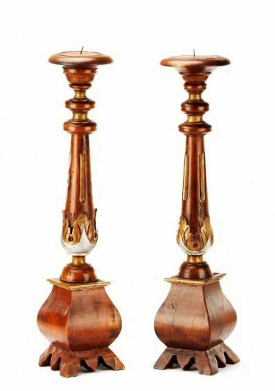Pair<br /><br />
DESCRIPTION:  A handsome pair of walnut wood Neoclassical style carved and stained candle prickets with circular tops above turned, tapered and fluted shafts with leaf tip ornaments, above swelled bases with splayed feet. Italian, 20th century; silver and gilt highlights on each. Unmarked, good condition. DIMENSIONS: Overall height 25.25".
<div id='rater_target1383289'></div>
