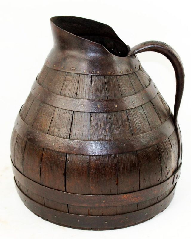 DESCRIPTION: An antique French wine pitcher crafted like a barrel from staves of wood bound by five hand wrought iron hoops.  The top hoop forms the neck and spout, the handle is iron wrapped wood. Originating from the Alsace region in eastern France, this pitcher is a wonderful compliment to any French, country or farmhouse décor. DIMENSIONS; 15" high x 12 1/4" diameter.

<div id='rater_target1384539'></div>
