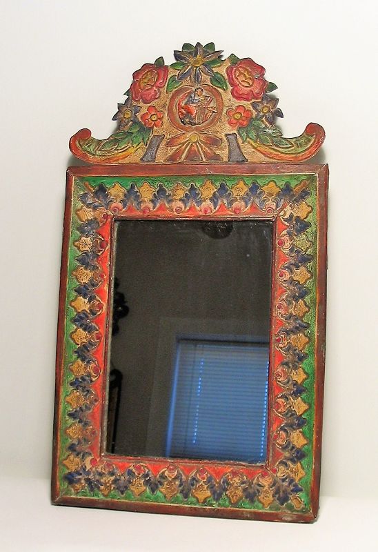 DESCRIPTION: An antique Spanish Colonial style painted sheet metal mirror, 19th to early 20th C., continental Europe. Acanthus leaves decorate the painted border, topped by an elaborate floral crest with center figural medallion. PROVENANCE: From the Collection of Eugene V. and Clare E. Thaw. CONDITION: Good, few minor dents to sheet metal. DIMENSIONS: 19.25" high x 10.75" wide.
<div id='rater_target1390284'></div>
