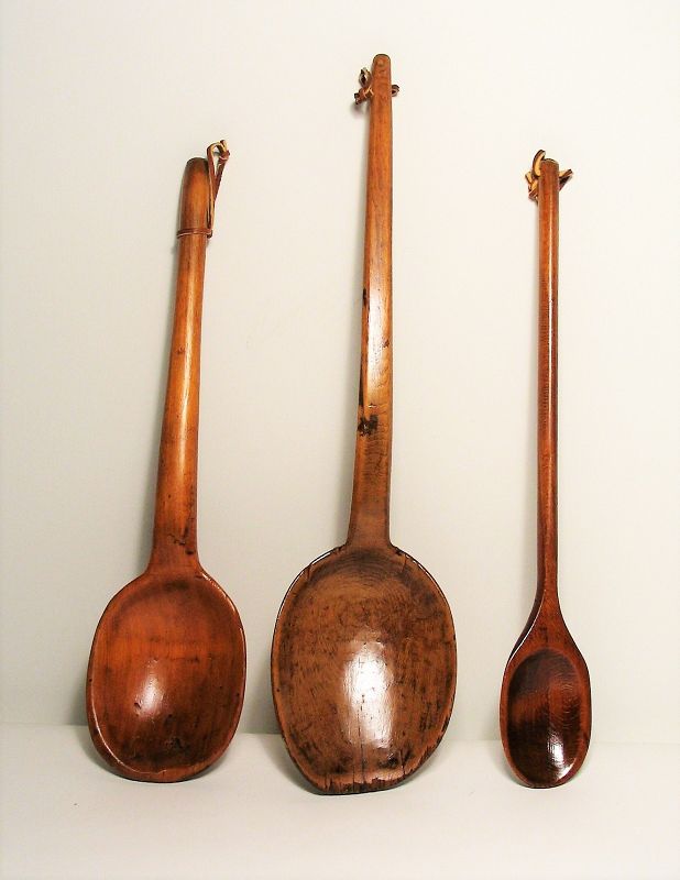 DESCRIPTION:  Three antique wooden kitchen spoons, hand carved from maple wood. These have been waxed showing a beautiful patina, and new leather straps are attached for display.  DIMENSIONS: Largest = 17” long x 4” wide;  smallest = 14.5” long x 2.25” wide.

<div id='rater_target1392726'></div>
