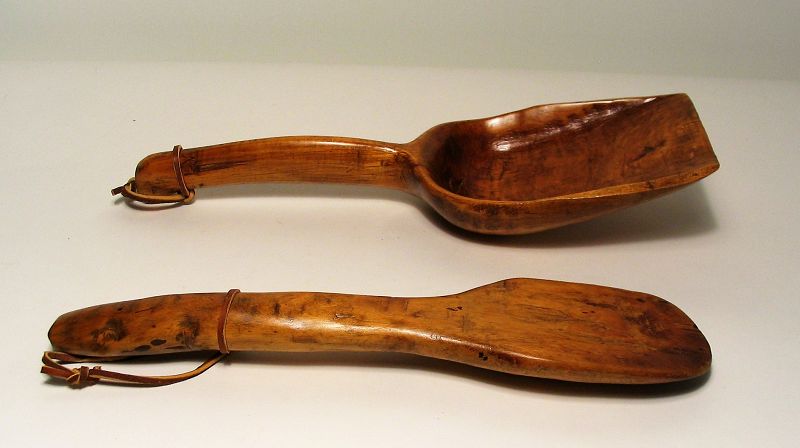 DESCRIPTION:  Nice old wooden spatula and shovel-shaped scoop, hand carved from maple wood. These have been waxed showing a beautiful patina, and new leather straps are attached for display.  DIMENSIONS:  Scoop = long x 4.24” wide.  Spatula = 12” long x 2 5/8” wide.

<div id='rater_target1397345'></div>
