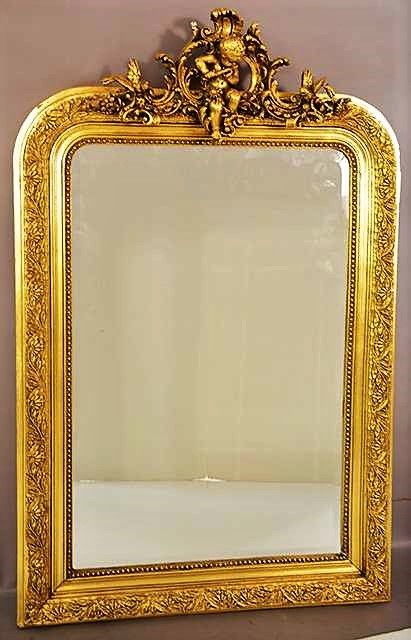 DESCRIPTION: An elegant French Louis XV style giltwood beveled mirror with center crest of birds and a cherub playing a flute, and framed with a gilt beaded and foliate border; Ca. 1890. DIMENSIONS:  46” high x 30” wide.
<div id='rater_target1397514'></div>
