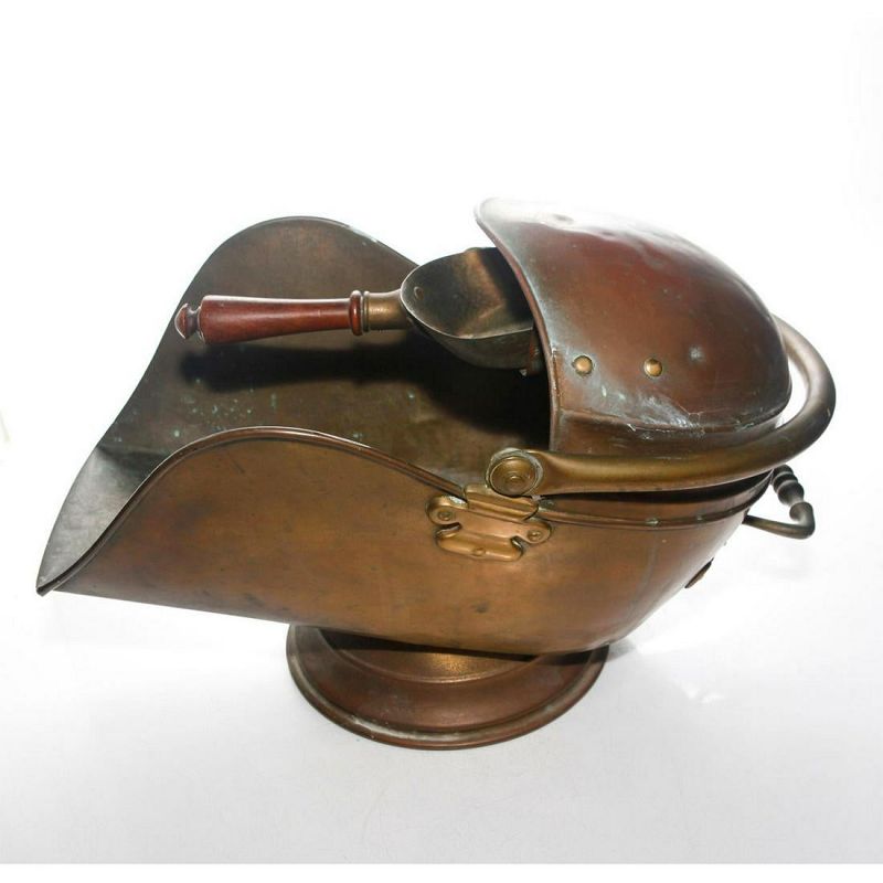 DESCRIPTION:  A handsome Victorian era (c. 1890) copper coal scuttle with brass handle and hinges, having a built-in copper “pocket” on the top to hold a shovel scoop.  These coal scuttles are practical today for removing ashes from your fireplace, and making a warm “hearth and home” statement. This one shows use with scattered small dents and a base repair.  DIMENSIONS: 13.5" High x 19.5" long.
A-MTL12     $315
<div id='rater_target1415856'></div>
