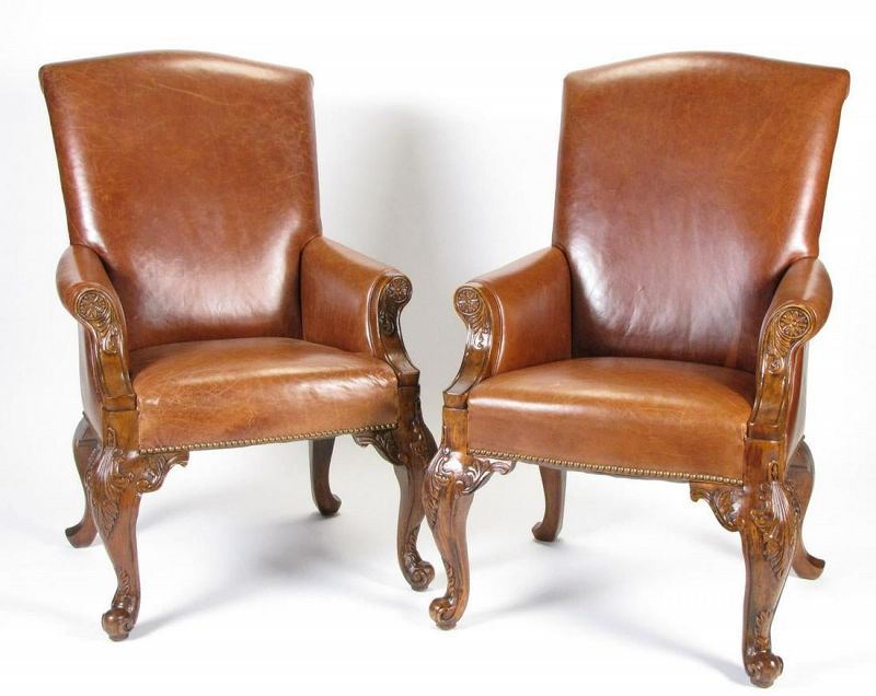 for the pair<br /><br />
DESCRIPTION: A handsome pair of high-back leather arm chairs, reminiscent of old English club or smoking chairs, with well carved wood cabriole legs, nail head trim, and carved wood trim at arms.  Light usage. DIMENSIONS:  43" high, seat 17.5” wide x 18.5” deep.
A-CH6   $1,795 Pair
<div id='rater_target1415970'></div>
