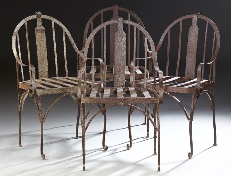 for the set of four<br /><br />
DESCRIPTION: A set of four wrought iron patio armchairs, the arched slatted backs with wide center slat curving gracefully to end in curved arm supports.  The seat is also slatted and sits above scrolled cabriole legs.  DIMENSIONS: Each 38 ½” High x 21 1/2'” Wide x 22” Deep.

<div id='rater_target1416303'></div>
