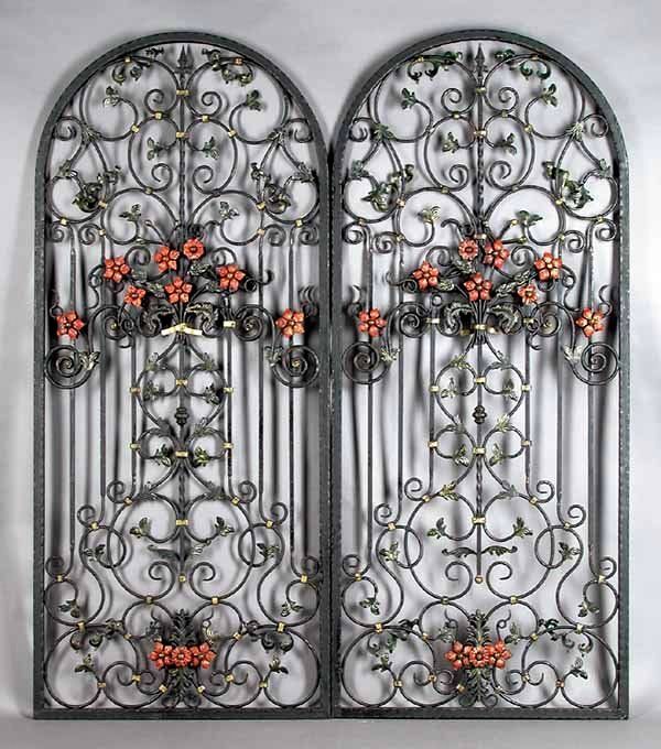 Pair<br /><br />
DESCRIPTION: An ornate pair of antique hand wrought and polychromed arched iron panels from a New Orleans estate. The workmanship on this pair is exquisite with a three-dimensional quality to the leafy vines and flowers. Both sides are equally crafted with double leaves and flowers so that there is no true front or back to each arched form. These could be made into entry gates with very little alteration or arched window guards. 

Dating from the late 19th C. and in excellent condition with no losses or rust issues, these superb architectural ornaments could not be duplicated for this same price today by a similar master craftsman. DIMENSIONS: 82 ½” high (2.1 m) x 35 3/8” wide (90 cm); widest depth is 3” (7.6 c).
<div id='rater_target1417120'></div>
