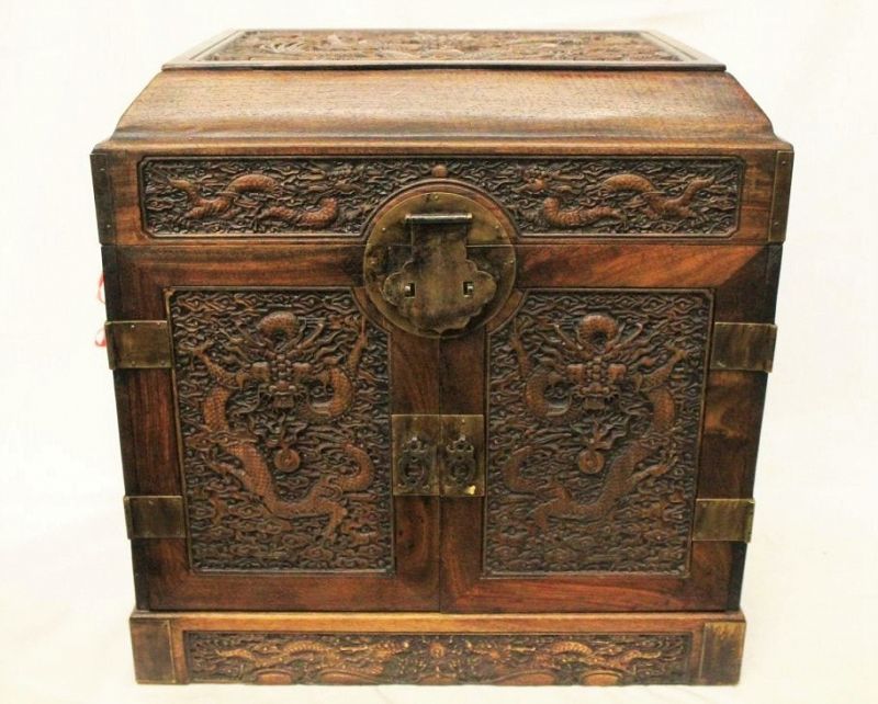 DESCRIPTION: A beautiful early 20th century Chinese huanghuali seal chest, elaborately carved in relief with fiery 5-toed dragons in clouds, the domed cover above double doors opening to reveal upper storage plus five lower drawers, and fitted flush with brass hardware and a ruyi form hasp.  Very good condition.  DIMENSIONS:  19.6" H x 19.25" W x 14.5" D.
SCH399  $4,390
<div id='rater_target1423035'></div>
