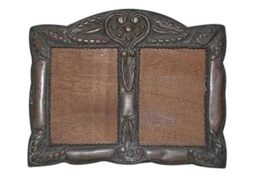 DESCRIPTION: Antique embossed copper double picture frame featuring a heart at the center crown and foliate leaves at the corners.  DIMENSIONS: 7 1/2" H X 9 1/2" W. PROVENANCE: From the private estate of a Peruvian gentleman; Houston, Texas. 

<div id='rater_target1472426'></div>
