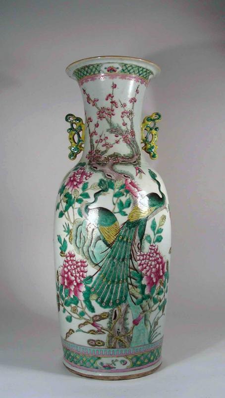 DESCRIPTION: An elegant Chinese baluster porcelain vase of a nice large size, profusely decorated in polychrome enamels in a famille rose pallet.  The design features a pair of green peacocks perched in a flowering prunus tree surrounded by large peonies.  On the reverse is a lovely garden scene with two beautiful maidens standing in front of a bamboo fence, supervising three young boys at play.  On the neck are two decorative handles in the form of vining tendrils.  This vase dates from the mid 19th century and has minor but appropriate wear for a piece this old with one small chip to one handle.  Nicely priced for such a large, genuinely old vase.  DIMENSIONS:  24” high (61 cm) x 10” diameter (25.5 cm).<div id='rater_target532860'></div>
