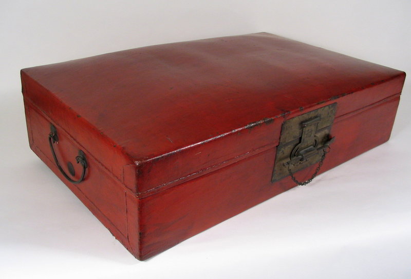 DESCRIPTION:  A handsome rectangular Chinese chest crafted from a deep red ox leather and furnished with brass fittings.  The interior still has the original blue silk lining and would have originally held scrolls or documents.  Today it would make an attractive accent piece on top or underneath a cabinet or table. Good condition with some scuffing on edges;  blue silk interior has some stains and small holes.  This chest originated from Zhejiang Province and dates from 1920-1940.  DIMENSIONS:  27 1/4" wide (69.2 cm) x 7" high (17.8 cm) x 17 1/2" deep (44.5 cm). <div id='rater_target1253675'></div>
