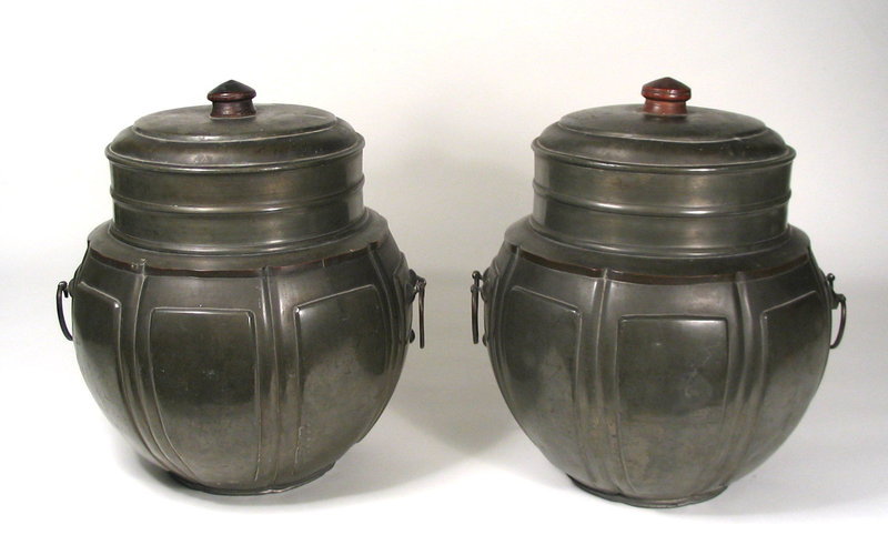 for the Pair<br /><br />
DESCRIPTION:  A pair of large antique Chinese tea caddies, or canisters, each having round, bulbous bodies with eight raised panels and two hanging metal handles.  Dating from 1850 - 1880, they both are topped with deep-rimmed lids with wooden knobs.  These decorative, large canisters have a pleasing form and wonderful presence; both very sturdy with good, solid weight.  Will make wonderful accent pieces or flower containers.  CONDITION:  Some minor surface blemishes, but overall in very good condition.  DIMENSIONS:  Each 11 3/4" high (30 cm) x 10 3/4" diameter (27.3 cm).  <div id='rater_target1264040'></div>
