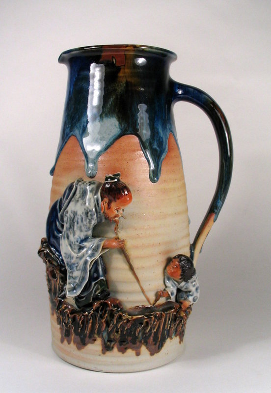 DESCRIPTION:  A large and fabulous Sumida Gawa tankard with an unglazed body, graceful handle, and figures of a man and small boy in very high relief.  A thick, flowing flambe' glaze in blues and brown coats the mouth and runs down the body and handle in thick drips.  Fine attention to detail has been paid to the handmade figures of a seated man with a cane facing a young boy, both supported by craggy rockwork ledges.  On the back in blue characters in a raised white cartouche is the potter's mark of Ishiguro Koko, also known as "Ban-ni," and considered by many to be the "Father of Sumida." Early 20th C. and in perfect condition; no chips or repairs.  From a Florida Sumida collection.  DIMENSIONS: 12" high (30.5 cm) x 7" wide (17.8 cm). <div id='rater_target1279752'></div>
