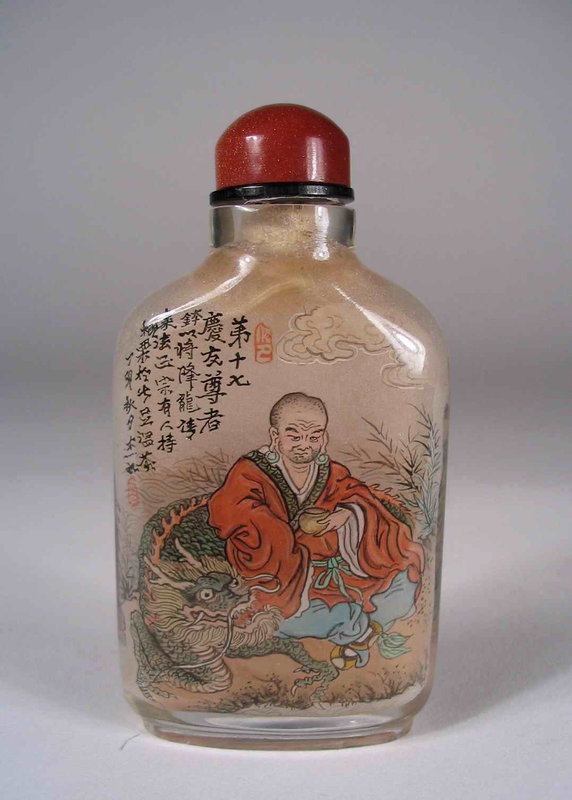 DESCRIPTION:  A finely painted Chinese glass snuff bottle in flattened rectangular form, each side featuring a lohan (a Buddhist disciple) in landscape settings, one with a crouching dragon and the other with a playful foo lion.  Above each lohan is a poem in fine calligraphy with red seal marks.  Aventurine stopper, in excellent condition, early 20th C.  DIMENSIONS:  3 ¼” high (8.3 cm). <div id='rater_target1287196'></div>
