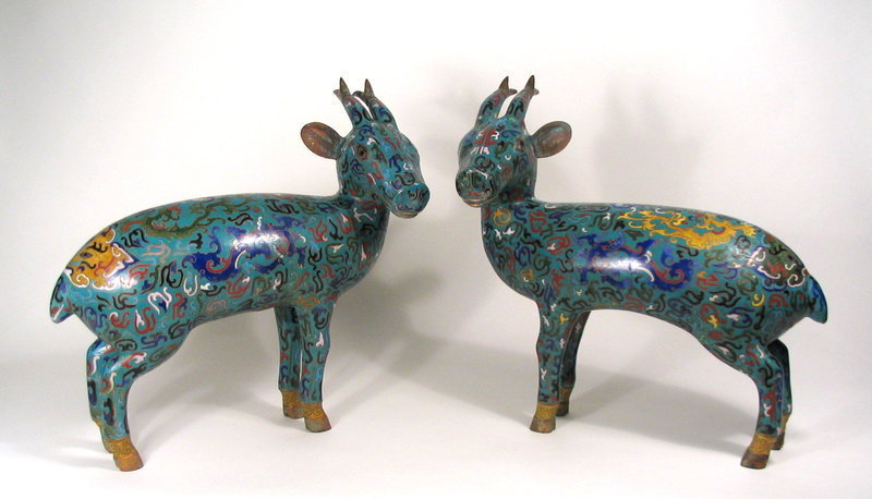 DESCRIPTION:  A colorful pair of Chinese cloisonne deer, both standing foursquare with heads turned, their bodies decorated with a profusion of designs including dragons and taotie masks, all on a turquoise blue ground.  These are a nice larger size, perfect for a table centerpiece.  Republic Period (1911 - 1949); very good condition.  DIMENSIONS:   Each 15.5" long (39.3 cm) x 15" high (38 cm).  <div id='rater_target1290887'></div>
