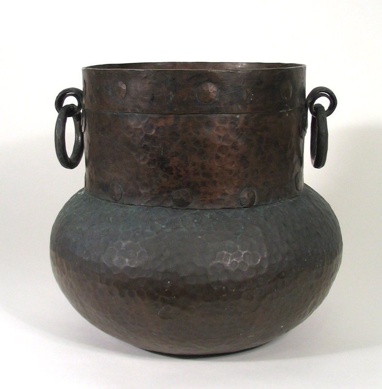 SOLD<br /><br />
DESCRIPTION:  A superb solid copper Spanish Colonial cooking pot with a wide banded straight neck and hand hammered bulbous body.  Large handmade brads hold the thick copper sheets in place, and two sturdy rings hang from downward curling supports. PROVENANCE:  Sourced in Chile while on a South American buying trip; early to mid 1800's.  This is a magnificent, solid pot in excellent original condition with age appropriate wear and patina. DIMENSIONS:  11" high (28 cm) x 12" diameter (30.5 cm).  <div id='rater_target1292501'></div>
