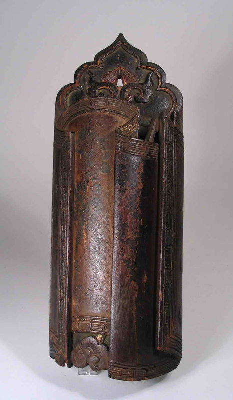 DESCRIPTION: A very old Chinese wooden incense holder, crafted in the form of a partially unrolled scroll that bends and folds to form the container.  On the edges of the “scroll” is a relief carved key pattern border with traces of gilt; the worn lacquer surface still shows the original designs of a bird, flower, bamboo and Chinese characters.  The top of the flat back plate has a shaped and carved design with a center hole for hanging.  On its reverse can be seen the old, hand forged iron nails used to fasten the two pieces together.  A handsome, unusual piece dating from the mid Qing Dynasty, 18th C., with surface showing aged wear. All the wooden parts are sturdy and intact.  DIMENSIONS:  13” long (33 cm) x 5” wide (12.7 cm).  <div id='rater_target1298963'></div>
