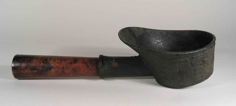 DESCRIPTION:  Before the availability of electricity and modern irons, this simple but useful implement was produced to iron clothes.  The long wood handle is attached to a large cast iron bowl designed to hold hot coals.  The bowl has been cast with designs on its outer surface and is shaped with one side flared to protect the worker’s hand.  After the bowl absorbed sufficient heat from the coals, it was pressed onto the garment using the flat bottom surface to smooth out wrinkles. Dating from the 19th C. and in very good condition.  DIMENSIONS:  13” long (33 cm); bowl is approximately 5” in diameter (12.5 cm). <div id='rater_target1302685'></div>
