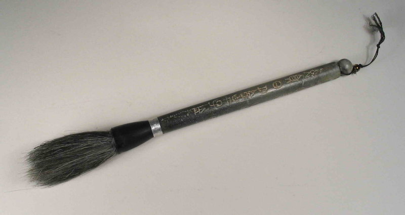 DESCRIPTION:  A Chinese scholar’s calligraphy brush, the brush crafted with natural bristles encased in a horn ferrule. These are secured with a silver band to a pitted green jade handle inscribed with archaic characters and terminating in a round knob.  A quality, well made brush in excellent condition, most likely dating to the latter Qing Dynasty to early republic Period.  DIMENSIONS:  9 ¼” long (23.5 cm). <div id='rater_target1304246'></div>
