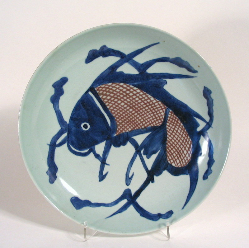 An attractive antique Chinese porcelain plate, hand painted with a large, leaping blue carp with russet colored cross-hatched scales.  The carp was an auspicious fish in China and a symbol of perseverance and success, often applied to success in business enterprises and state examinations.  In excellent condition (no cracks, chips or hairlines), this deep-dish plate would have served as a large shallow bowl as well.  Dating from the Yongzheng to Qianlong Periods (AD 1723 - 1795), this plate is of a larger size than most similar fish plates.  Please see the last photo for a size comparison with one of a pair of our already listed fish plates, stock number CP3&4.  DIMENSIONS:  11.25" diameter (28.5 cm) x 2.25" high (5.7 cm). <div id='rater_target1310419'></div>
