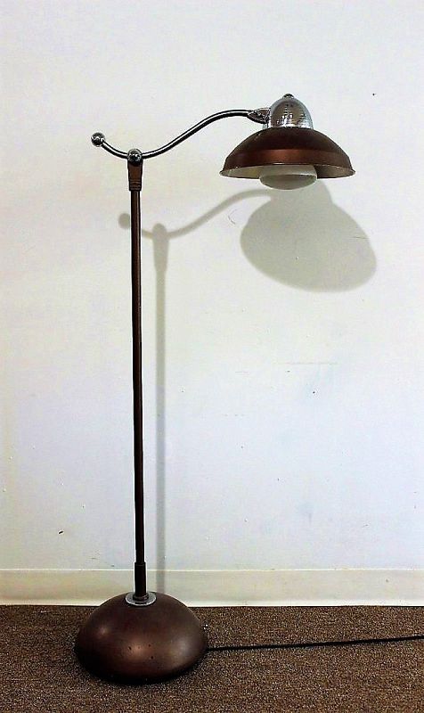 Here is a fabulous 1930’s Art Deco industrial metal floor lamp, waiting to give your home or office that vintage look. These early electrical devices are so stylish now for the popular Industrial / Steampunk / Machine Age décor.  The entire upper section of the lamp is adjustable, and the head moves as well. In excellent original condition (works great) with beautiful chrome accents.  DIMENSIONS:  64.5” tall x 14” wid
<div id='rater_target1364607'></div>
