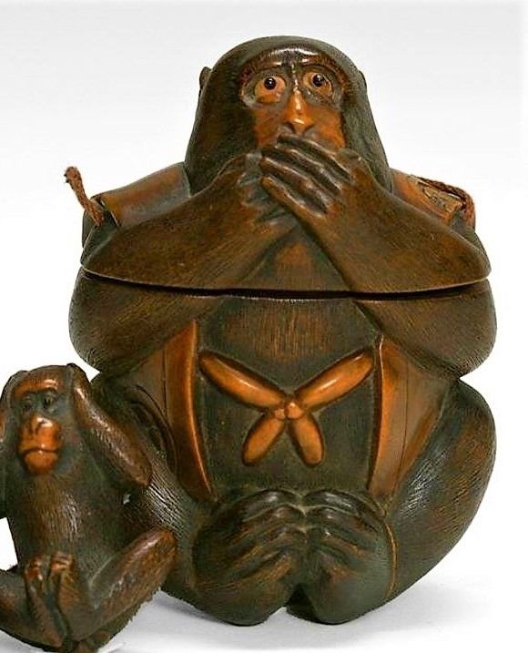 DESCRIPTION:  This outstanding and rare antique Japanese Tonkotsu, or tobacco box, has been crafted from boxwood in the form of the Three Wise Monkeys, with a beautifully carved Iwazaru, or “Speak no Evil” monkey, serving as the main tobacco container.  Mizaru, or “See No Evil”, forms the ojime and Kikazaru, or “Hear No Evil”, forms the netsuke to complete the set.  Each of these has been meticulously carved with inlaid eyes and finely delineated fur.  The large monkey wears a decorative jacket and holds the artist’s signature on his rump. These tobacco boxes were worn by men in a similar fashion as an inro, suspended from a belt or sash.  This example is one of the finest mingei (folk art) pieces we have seen.  Mid 19th C., in very good condition with no restorations; small age fissure on large monkey’s shoulder. DIMENSIONS: Large Monkey is 3 ½” high (9 cm).
<div id='rater_target1365836'></div>
