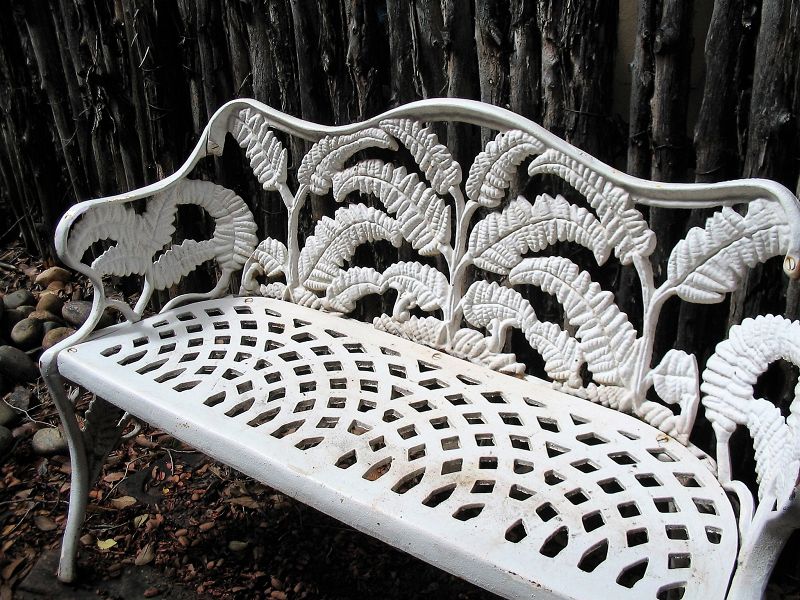 DESCRIPTION: A late 19th to early 20th century cast iron garden bench with serpentine crest over the back and side arms and a classic openwork fern pattern with pierced seat, the naturalistic legs having side stretchers with similar fern decoration. Very good condition; light, scattered rust spots, paintable.  DIMENSIONS: 41" wide x 27 1/2" high; seat height is 14 1/2"
<div id='rater_target1366714'></div>
