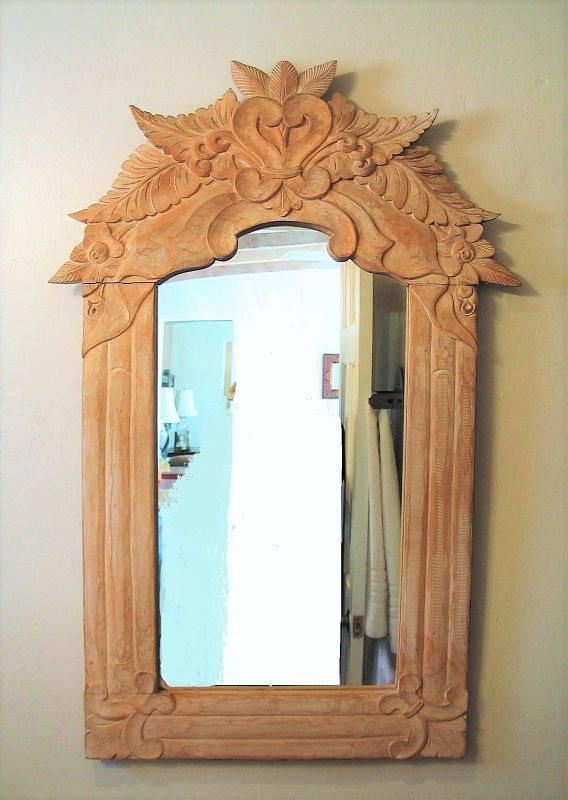 DESCRIPTION:  A delightful rustic Mexican mirror with hand carved pine frame, the crown a flourish of leaves and flowers with center heart-form scrolls.  Very good condition.  DIMENSIONS: 35.25” high x 23.5” wide.
<div id='rater_target1373315'></div>
