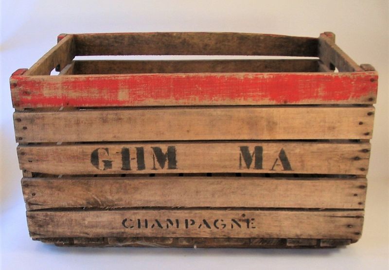 DESCRIPTION:  A sturdy wooden champagne grape box or crate used in French vineyards at harvest time.  This one has touches of red paint, “GHM MA CHAMPAGNE” stenciled on both sides and handholds notched into the slats at the top. These boxes enhance a country provincial decorating style while functioning as split log holders for the fireplace or the perfect place to toss your wet or snowy boots in winter.  DIMENSIONS: 15 ½” high x 27"wide x 19 1/2"deep.
<div id='rater_target1373441'></div>
