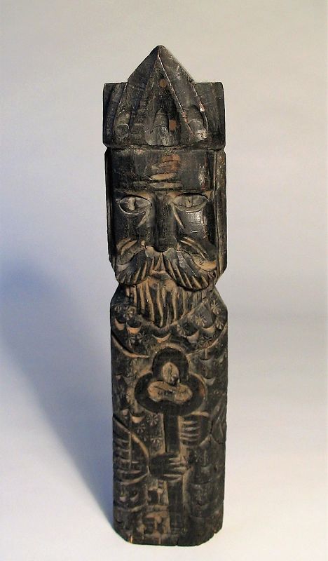 DESCRIPTION:  An antique Mexican folk art carving of a bearded St. Peter in a bishop’s hat holding a large key, symbolizing the key to the kingdom of heaven entrusted to disciple Simon Peter by Christ. This figure was probably part of a home devotional altar; figure can also be hung on a wall or entry door.  Very good condition. DIMENSIONS: 13 1/8” high x 3”wide.
<div id='rater_target1373524'></div>
