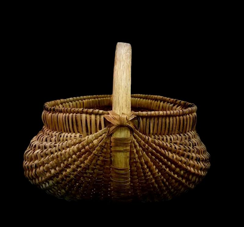 DESCRIPTION: Beautiful melon-shaped split oak basket with a sturdy bentwood handle and oak-wrapped wide rim. This early 1900’s folk art basket is in great condition with no major losses noted. DIMENSIONS: 18" long x 14.5" wide; height with handle is 13.75", without is 8.75".   
<div id='rater_target1382253'></div>
