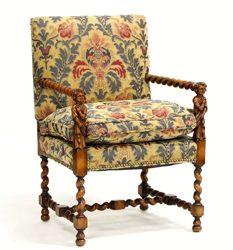 DESCRIPTION:  An early 20th century William and Mary style arm chair with hand carved walnut “barley twist” legs, stretchers and arms, the arms terminating in carved figural arm supports. Blue, red and beige tapestry style upholstery covers the back and seat cushion, all finished with nail head trim. This is a quality accent chair that will add Old World ambiance to your home. Collection of Dr. O'Quinn & Nathan Smith, Raleigh, NC.  CONDITION: Minor surface wear; upholstery in good, clean condition.  DIMENSIONS: 39” high x 26” deep x 24” wide.
<div id='rater_target1382538'></div>
