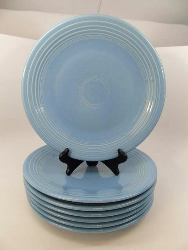 for set of eight<br /><br />
DESCRIPTION: A hard to find set of eight periwinkle blue (color retired) Fiesta dinner plates.  Nothing says Americana or “Country Cottage” like Fiesta dinnerware, which can be mixed and matched with other Fiesta colors. Periwinkle blue was introduced by Fiesta in 1989 and discontinued in 2006; this set’s logo would date these plates to pre 1992.  CONDITION:  Light ware, no chips, good condition. DIMENSIONS: 11.5" diameter each.
A-CP4   $185 for set of eight
<div id='rater_target1382709'></div>
