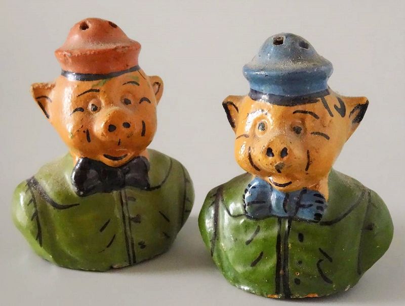 Pair<br /><br />
DESCRIPTION:  A charming pair of earthenware hand-painted piglet salt and pepper shakers, each pig sporting a bow tie and cap. Good condition, “MEXICO” stamped on base, cork stoppers. DIMENSIONS: Each approximately 3" high.

<div id='rater_target1383545'></div>
