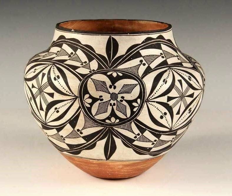 DESCRIPTION:  Fine Acoma Pueblo terra cotta olla, circa 1920, with intricate black on white geometric designs with blossom, eye and cross themes; unsigned, good condition, no chips or repairs. DIMENSIONS: 8 3/4" high x 9 1/8" diameter.
<p>ABOUT ACOMA POTTERY:  Thin, hand fired walls (a common and sought after characteristic of Acoma pottery), light weight, and geometric designs characterize Acoma pottery. The Acoma Pueblo, also known as "Sky City," is located 50 miles west of Albuquerque near Enchanted Mesa, and is one of the oldest continually inhabited sites in North America. The area is home to particularly good clay, which potters mix with a temper of crushed potsherds. This results in the ability to produce very thin and lightweight, yet strong pottery. 
<p>Traditional designs range from complex geometrics to abstract animal, floral and figurative forms. Coloration consists predominantly of black and white, or black, white and orange although other colors also appear infrequently. Acoma clay is grey in color and potters achieve their white surface with a slip of kaolin, a naturally occurring chalky material that is a brilliant white. Black is made from crushed iron-rich hematite and/or the liquid from boiled wild spinach, which are often mixed together. There are no schools or universities that teach the complex techniques and skills necessary to make Native American Acoma Pottery. It takes many years to learn, requires much dedication and sacrifice, and is a skill passed down by the elders from generation to generation. 
<div id='rater_target1387159'></div>
