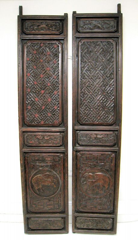 DESCRIPTION: A pair of substantial, deeply carved Chinese doors originating from Zhejiang province and dating from the early 1800’s, Qing dynasty. These handsome, heavy solid elm doors still have all of their original pegs attached, which would have been set into round sockets at the top and bottom, allowing the doors to be opened and closed. 
<p>The top panels are carved with flowers and a repeating swastika pattern, the Chinese character meaning good fortune or longevity. A pair of carved citron, or Buddha’s Hand fruit, decorates the middle horizontal panels, so named because their form resembles a classic position of the Buddha’s hand. The large bottom panels each contain a rabbit in raised relief within a circle. The rabbit is the fourth position of the Chinese Zodiac, symbolizing such character traits as creativity, compassion, and sensitivity. 
<p>DIMENSIONS: 93 ¼” tall (2.37 meters) x 20” wide (51 cm) x 2 ¾” thick (7 cm). 
<div id='rater_target1390720'></div>
