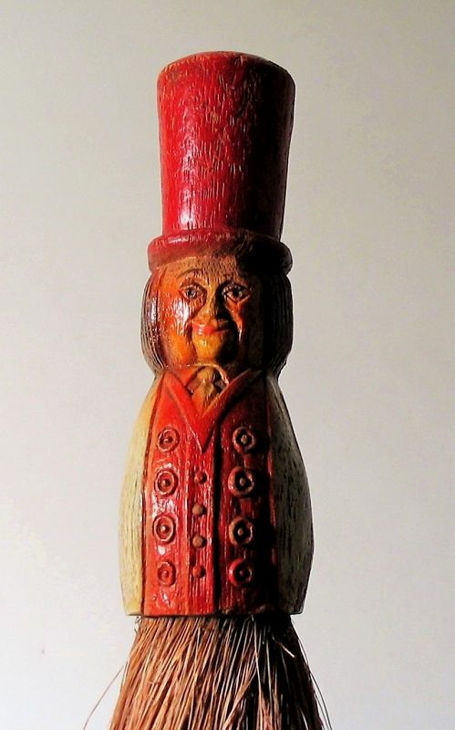 DESCRIPTION:   A whimsical lint clothes brush, the wood handle carved in the form of a gentleman in a formal jacket wearing a red top hat.   Most of the original paint remains; the long brush bristles are horsehair.  DIMENSIONS:  8” long x 1.5” diameter. 
<div id='rater_target1391978'></div>

