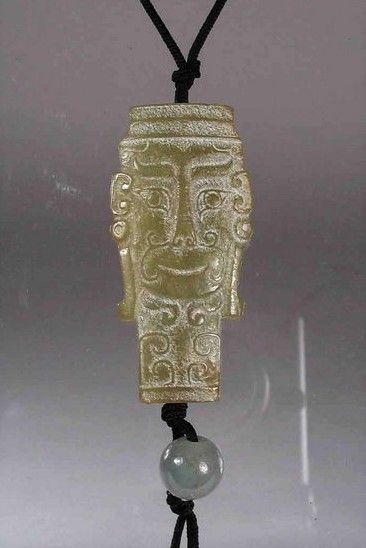 DESCRIPTION: A Chinese celadon jade pendant, both sides well carved in the form of an archaic mask and strung on a black nylon cord with a round celadon jade bead. Such amulets have a long history in China and would have been worn as a mystical protector against all unseen evil and bad luck. This handsome jade pendant is quite wearable and in excellent condition.  DIMENSIONS: 2 ¼” long (5.7 cm)

<div id='rater_target1416508'></div>
